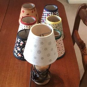Cute 10” lamp with 7 lampshades. Made from bobbin.  Has on and off switch.